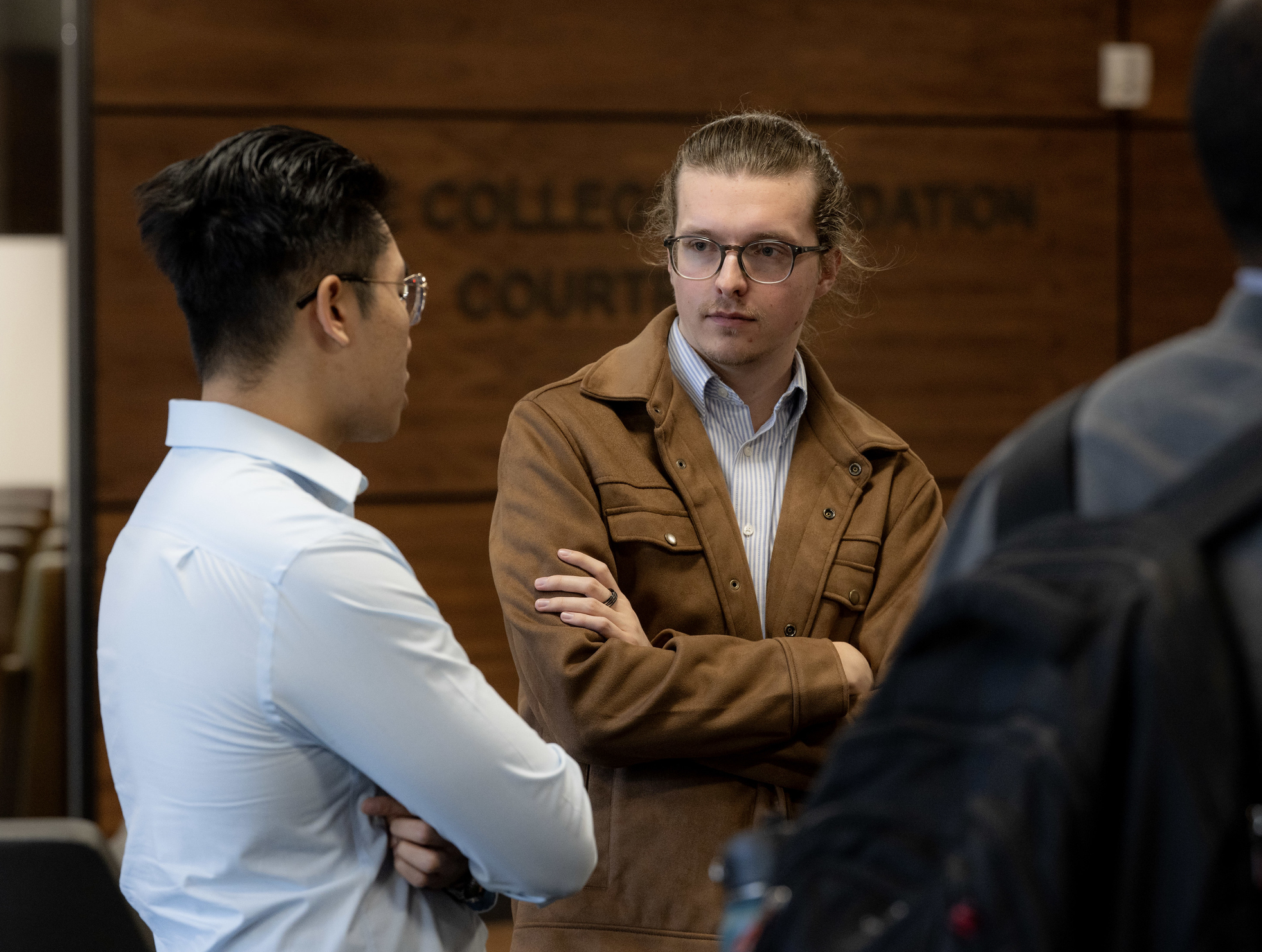 Chase students talking to each other outside of courtroom.