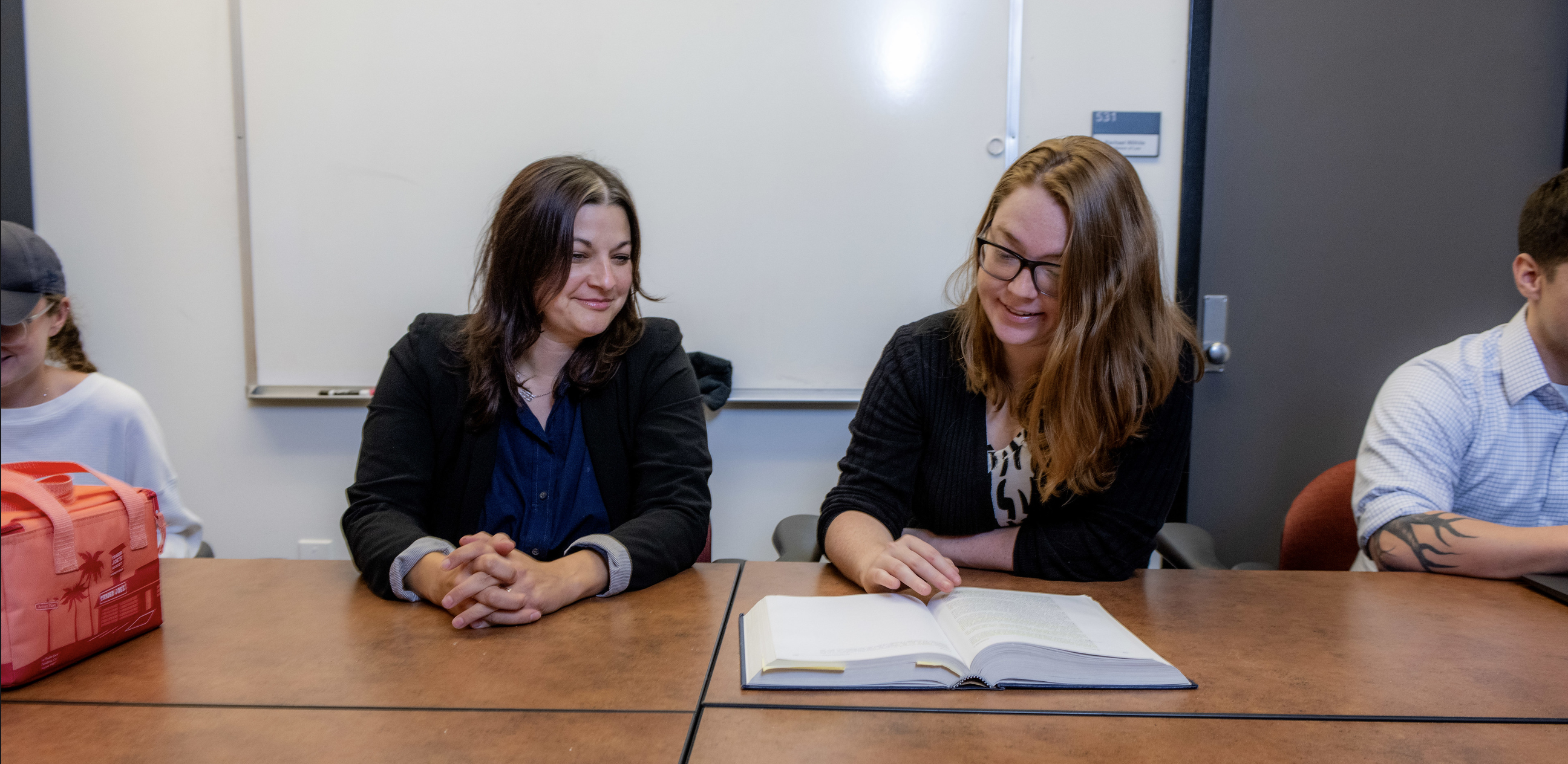 Two students studying together at a table.