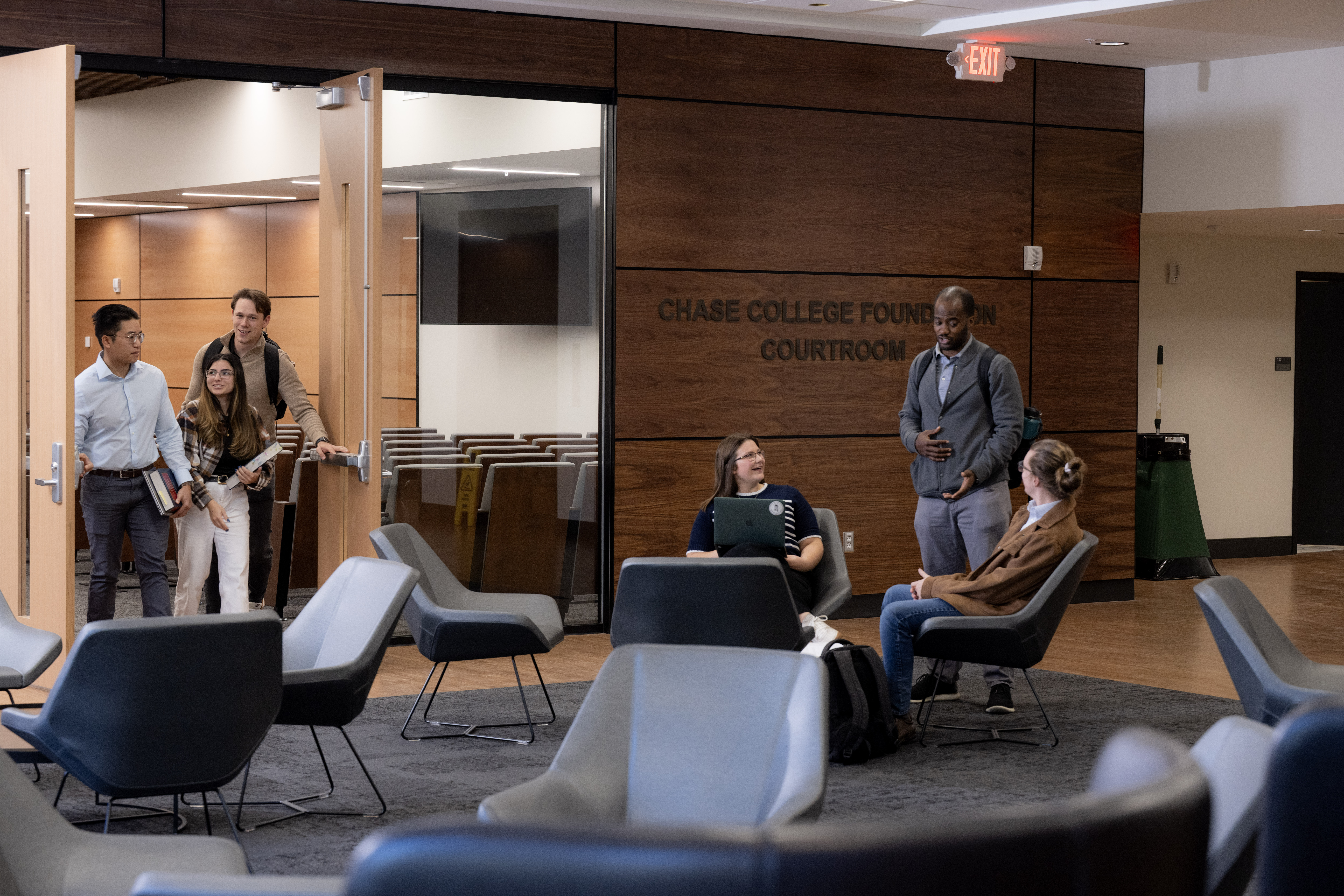 Students conversing outside the Foundation courtroom