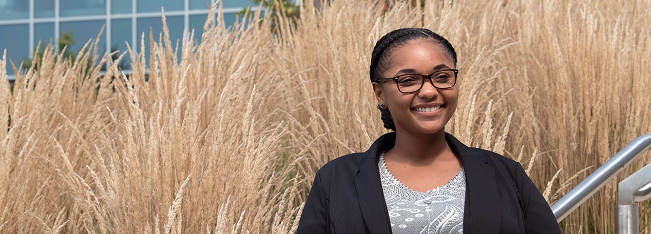 Smiling student standing outdoors on NKU's campus