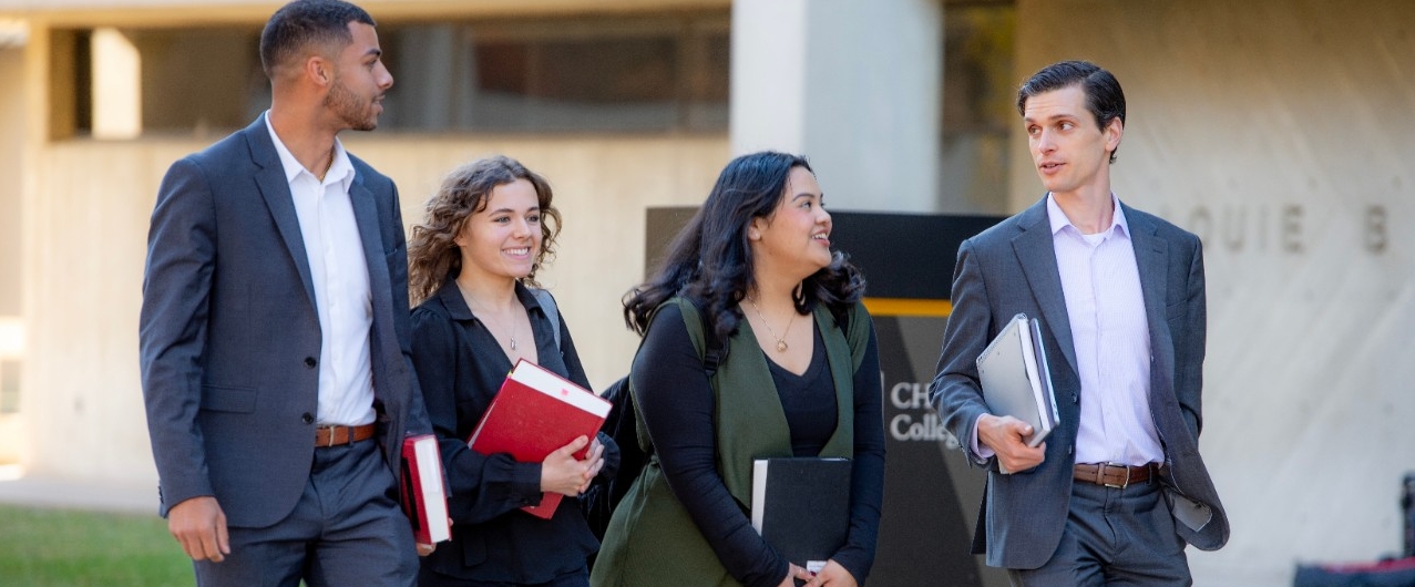 Three professionally dressed Chase students walking together.