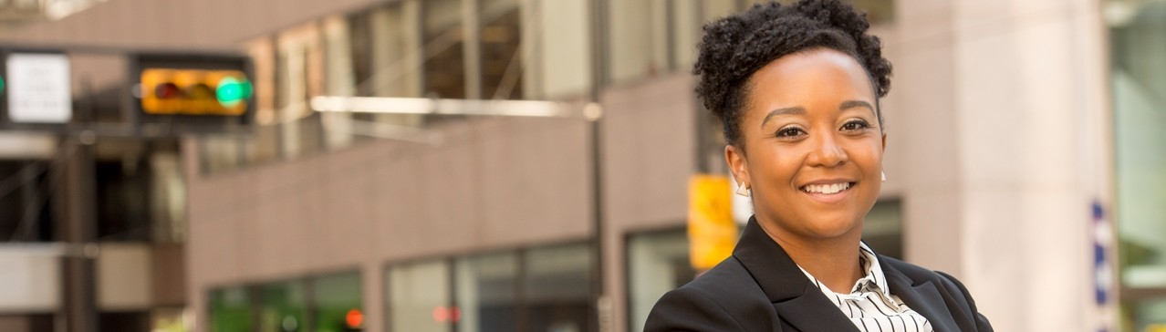 Smiling woman dressed professionally.